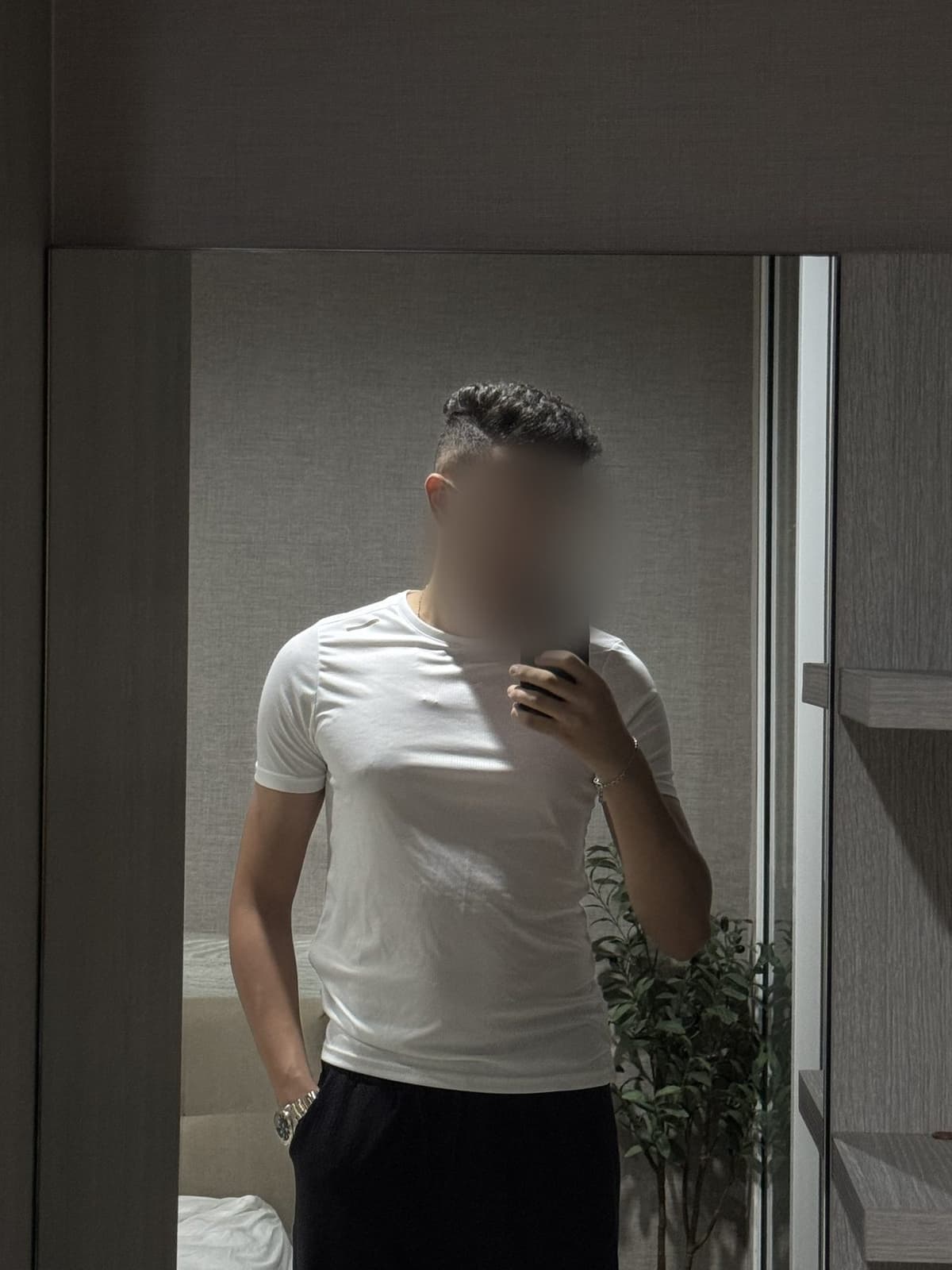 Mehdi in a fitted white t-shirt, filled out at the chest and arms