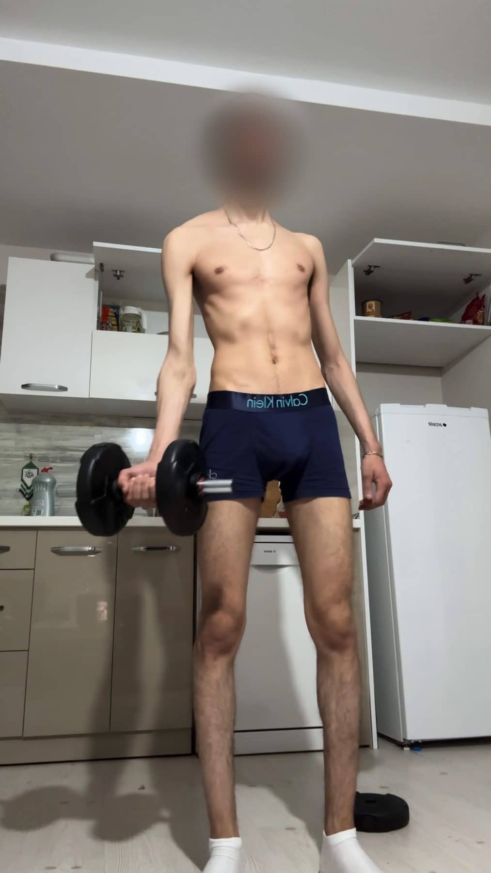 Mehdi on day 1 in the kitchen, very thin, a dumbbell in each hand